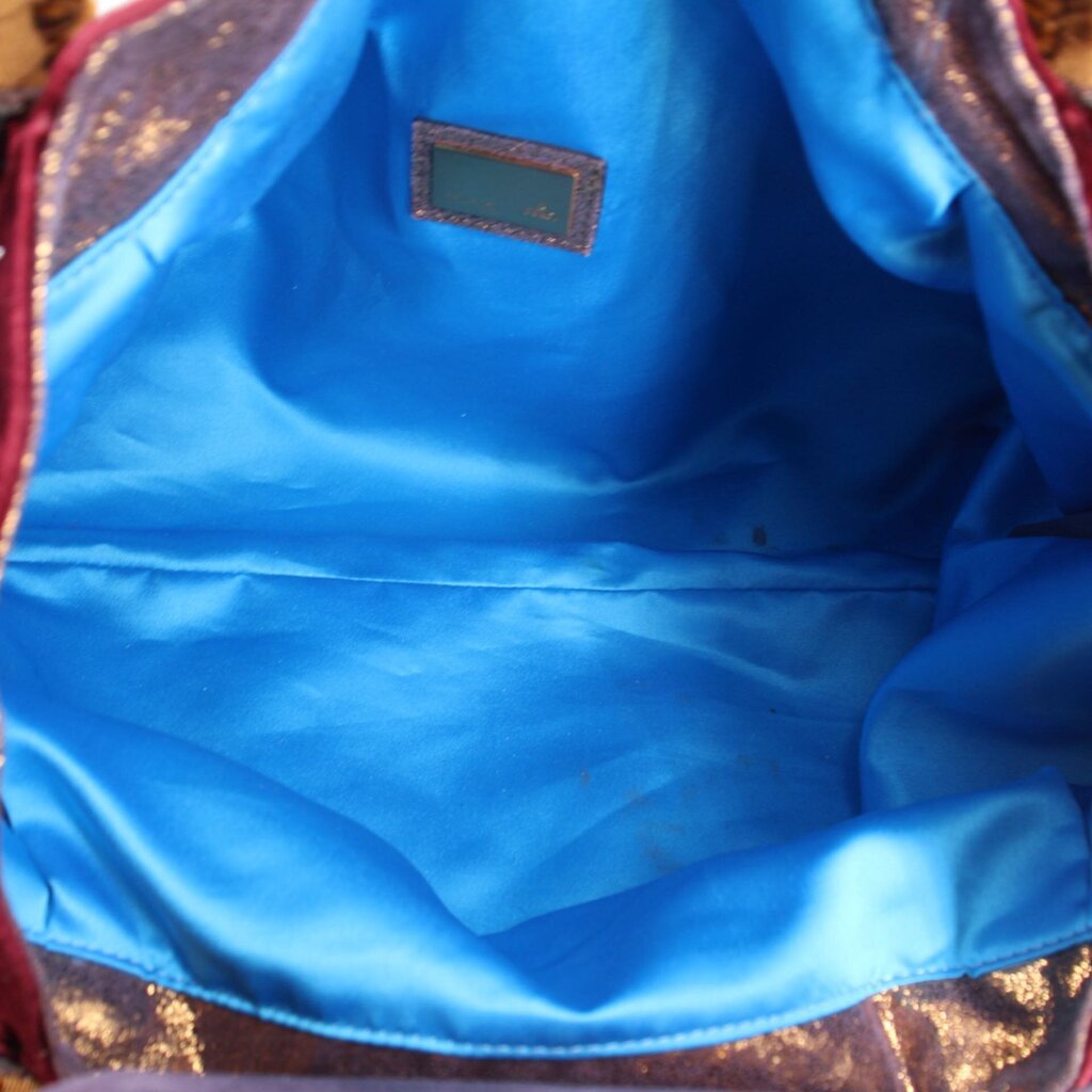 Bag interior with blue lining and small rectangular brand label patch