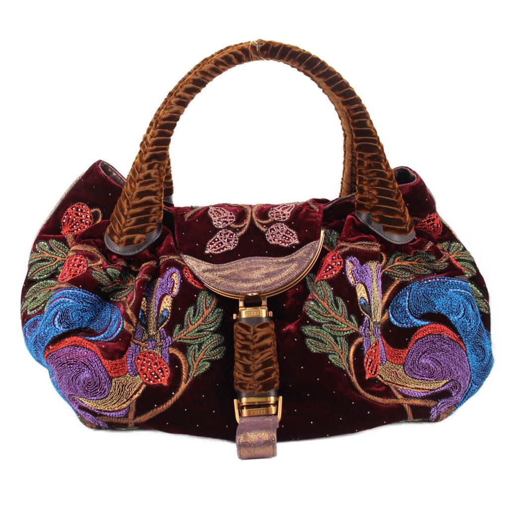 Maroon velvet mini bag with top handles, embroidered motifs, and front clasp detail