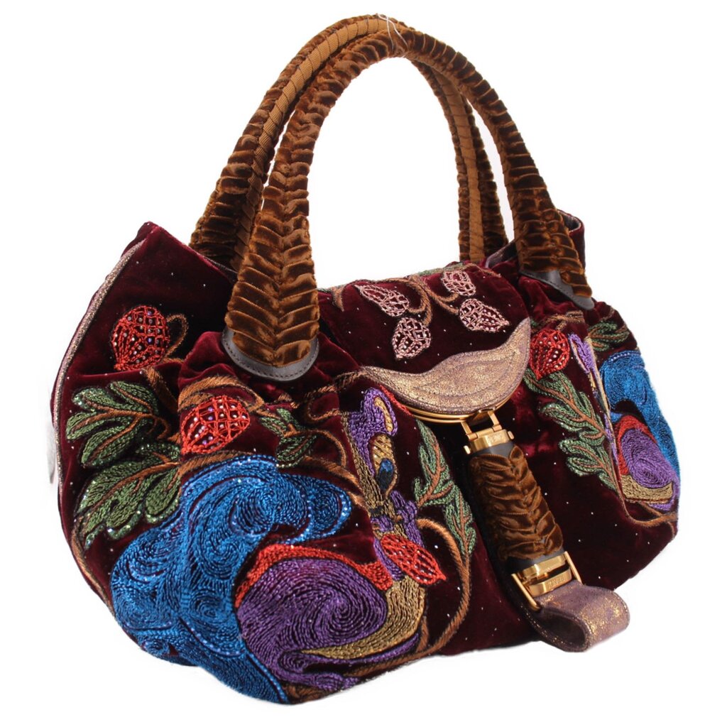 Maroon velvet mini tote bag with woven top handles, ornate embroidery, and front strap charm