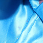Blue satin-style lining fabric inside the bag, folded creases visible