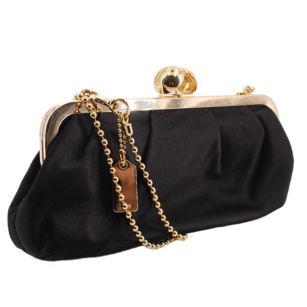 Black satin kisslock shoulder bag with gold frame clasp and dangling chain strap