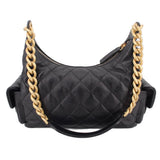 Black quilted hobo bag with top zipper and two gold-tone chain straps
