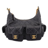 Black quilted leather hobo bag with gold chain handles and front pocket flaps
