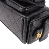 Close-up of black quilted hobo bag with gold CHANEL CC push-lock clasp