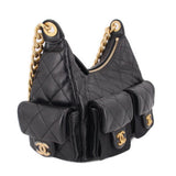 Black quilted hobo bag with side pocket flaps, gold-tone chain, and CHANEL logo