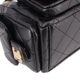 Close-up of black quilted hobo bag front pocket flap and gold-tone clasp