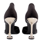 Black satin heels in back view with slim stiletto heel and metal-look heel cap