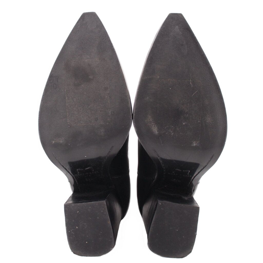 Black ankle boot outsoles with block heel—bottom view.
