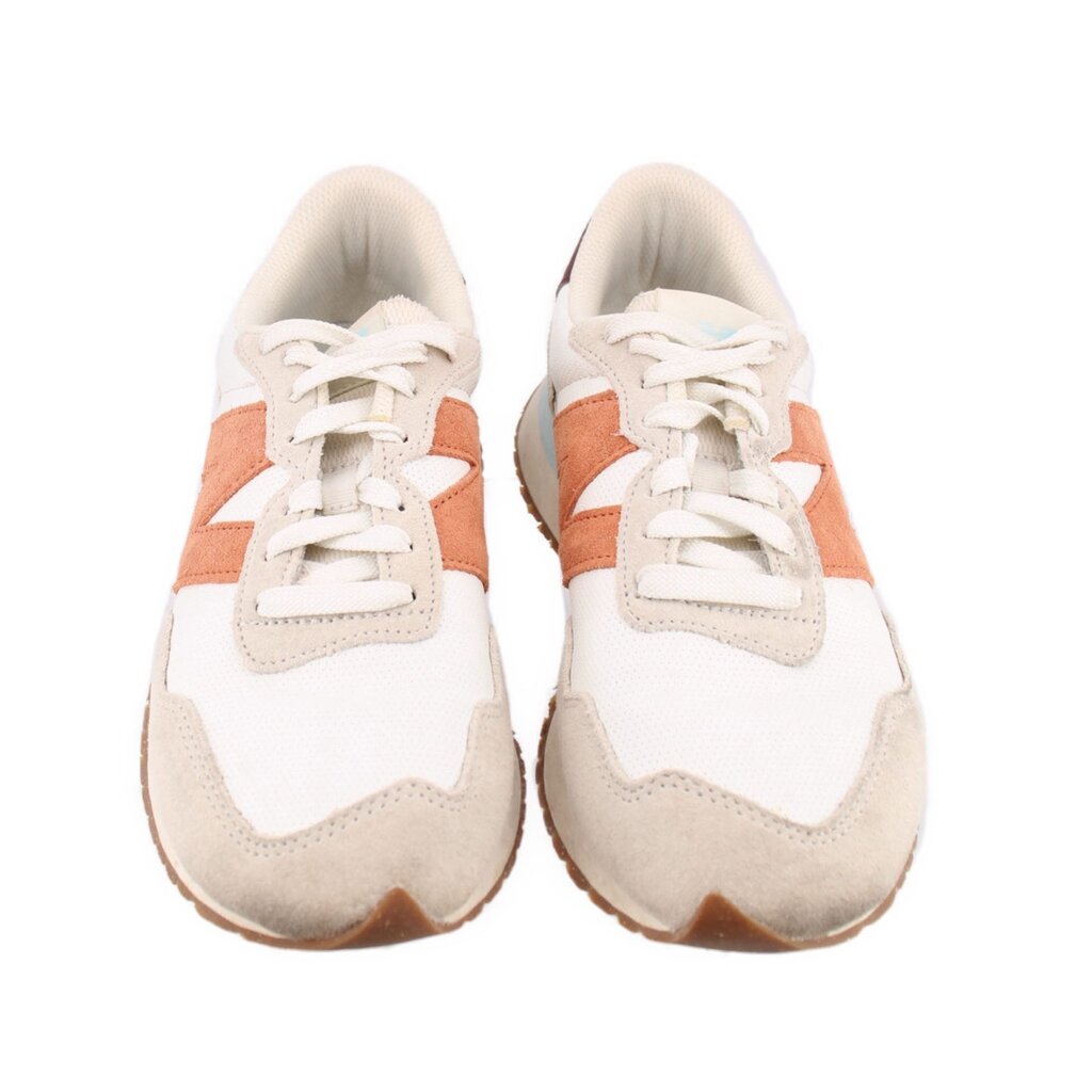 Pair of beige suede sneakers with orange stripes, white laces, and cushioned tongue