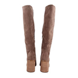 Pair of brown suede knee-high heeled boots with tall shafts and stacked heels