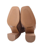 Brown boot soles and block heels with textured tread