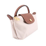 Beige fabric pouch with brown leather flap, loop handle, and gold-tone clasp