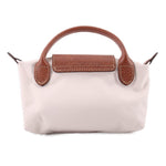 Beige fabric pouch with brown leather handle accents and center top flap