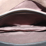 Black boxy crossbody bag open, showing fabric lining and interior seam details