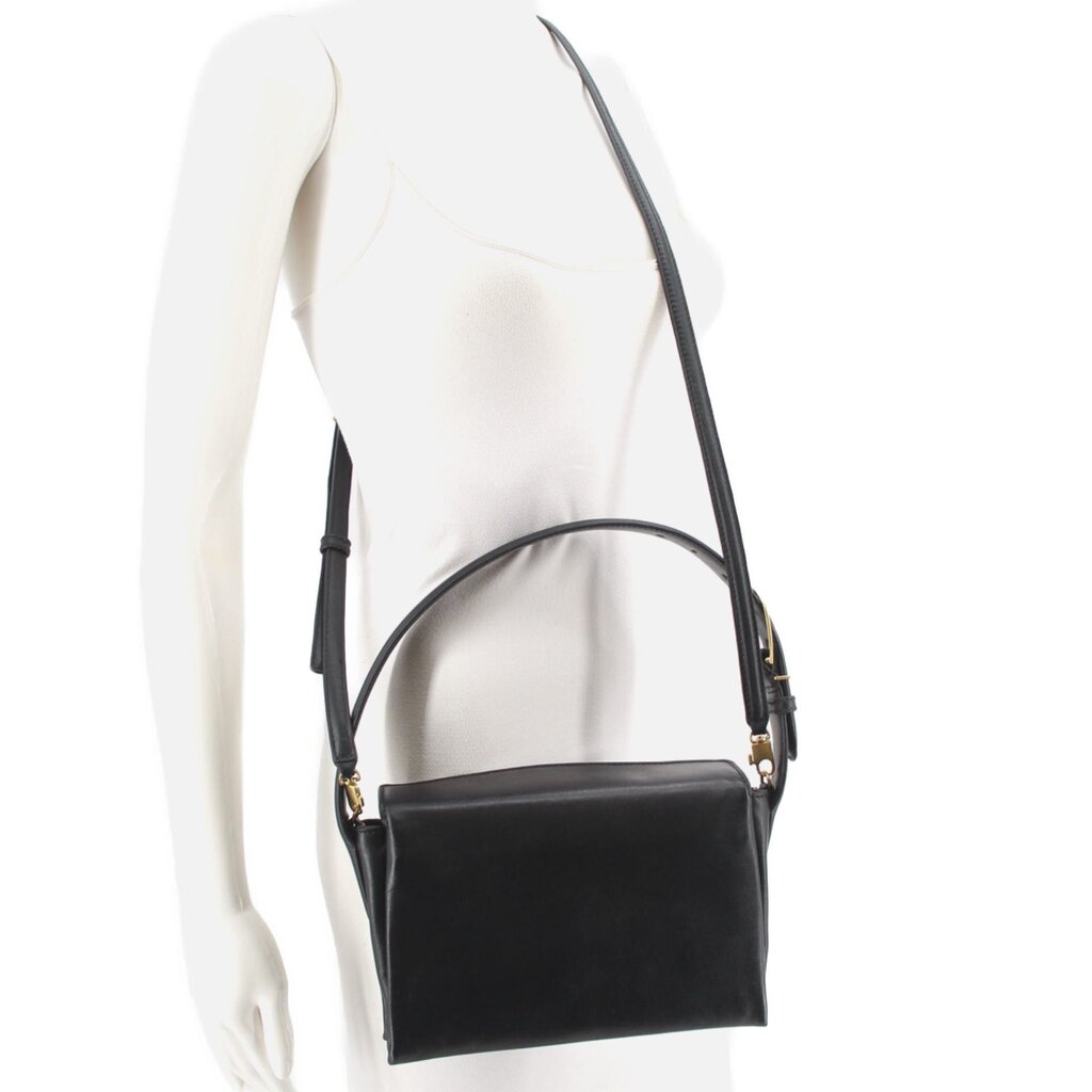 Black boxy crossbody bag worn crossbody with adjustable strap and flap front