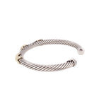 Sterling silver cable bracelet with 14K gold knot detail and curved end