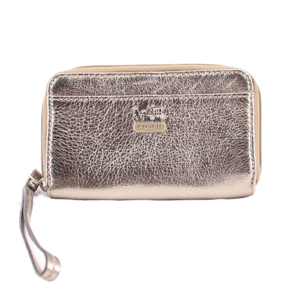 Metallic gold leather zip-around wallet with COACH logo and wrist strap