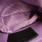 COACH shoulder bag interior lining with purple fabric and black pocket panel