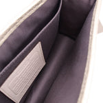 Coach Penny crossbody interior, gray fabric lining with leather pocket panel.