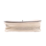 Coach Penny crossbody bag bottom edge, metallic gold leather with stitched trim.