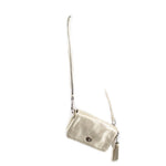 Coach Penny crossbody bag with pouch, metallic gold, hanging side view with long strap.