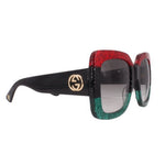 Oversized sunglasses side view, dark lenses, red glitter front and black temple with GG logo