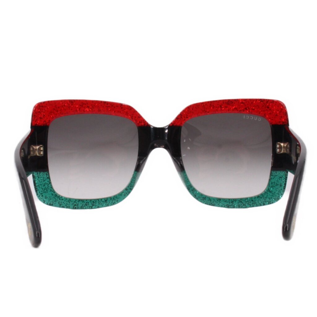 Oversized sunglasses front view, dark lenses, red glitter top and green glitter bottom