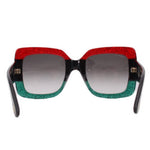 Oversized sunglasses front view, dark lenses, red glitter top and green glitter bottom