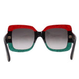 Oversized sunglasses front view, dark lenses, red glitter top and green glitter bottom