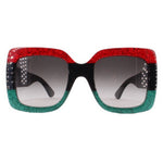 Oversized sunglasses with dark lenses and red-to-green glitter frame, black accents