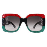 Oversized sunglasses with dark lenses and red-to-green glitter frame, black accents