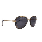 Black and gold cat-eye sunglasses with dark lenses and metal temple detail