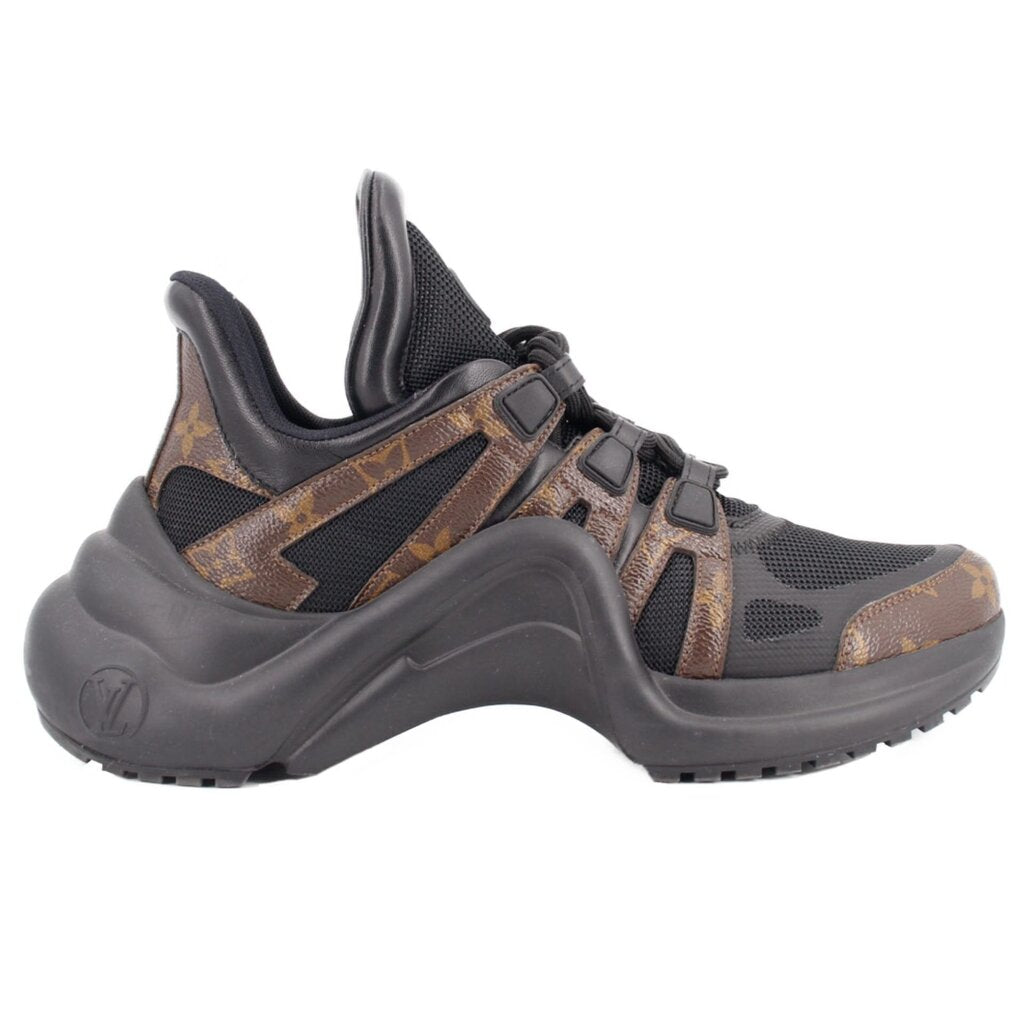 Black monogram sneakers, side view with sculpted sole and strap over laces