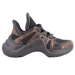 Black monogram sneakers, side view with sculpted sole and strap over laces