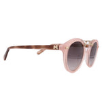 Blush pink sunglasses side view with dark tinted lenses and brown temples