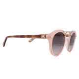 Blush pink sunglasses side view with dark tinted lenses and brown temples