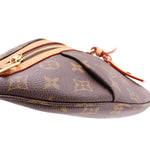 Close-up of monogram belt bag edge with top zip and leather strap
