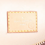 Close-up of tan leather tag inside belt bag reading LOUIS VUITTON PARIS