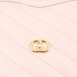 GUCCI cream heart crossbody bag close-up of GG heart emblem on quilting