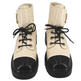 Pair of cream lace-up ankle boots with black toe caps and chunky soles