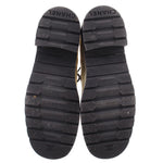 Black boot outsoles with CHANEL tread logo