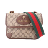 Brown GG monogram crossbody bag with front flap, striped strap, and Gucci lion plaque