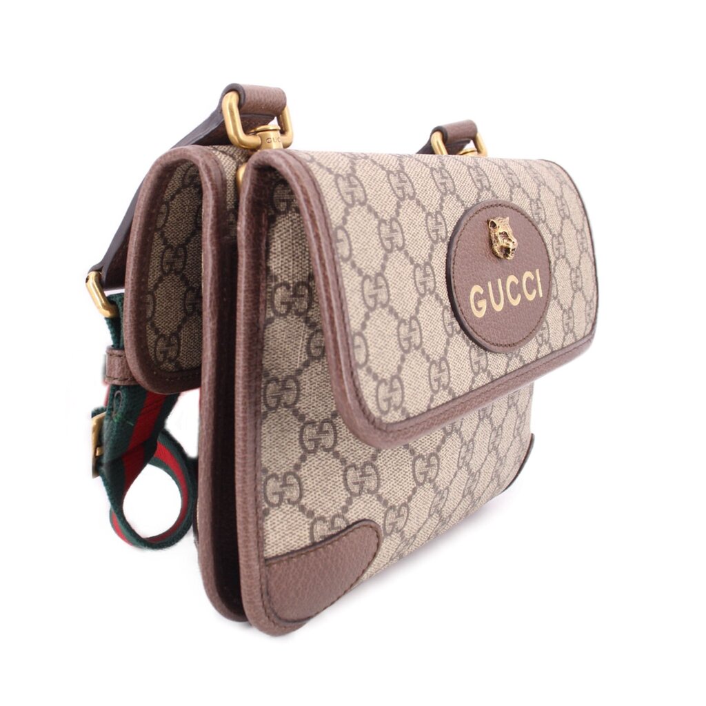 Brown GG monogram messenger crossbody with flap closure and gold-tone Gucci badge