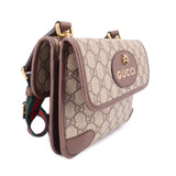GUCCI GG canvas crossbody bag side view with flap logo medallion and brown trim
