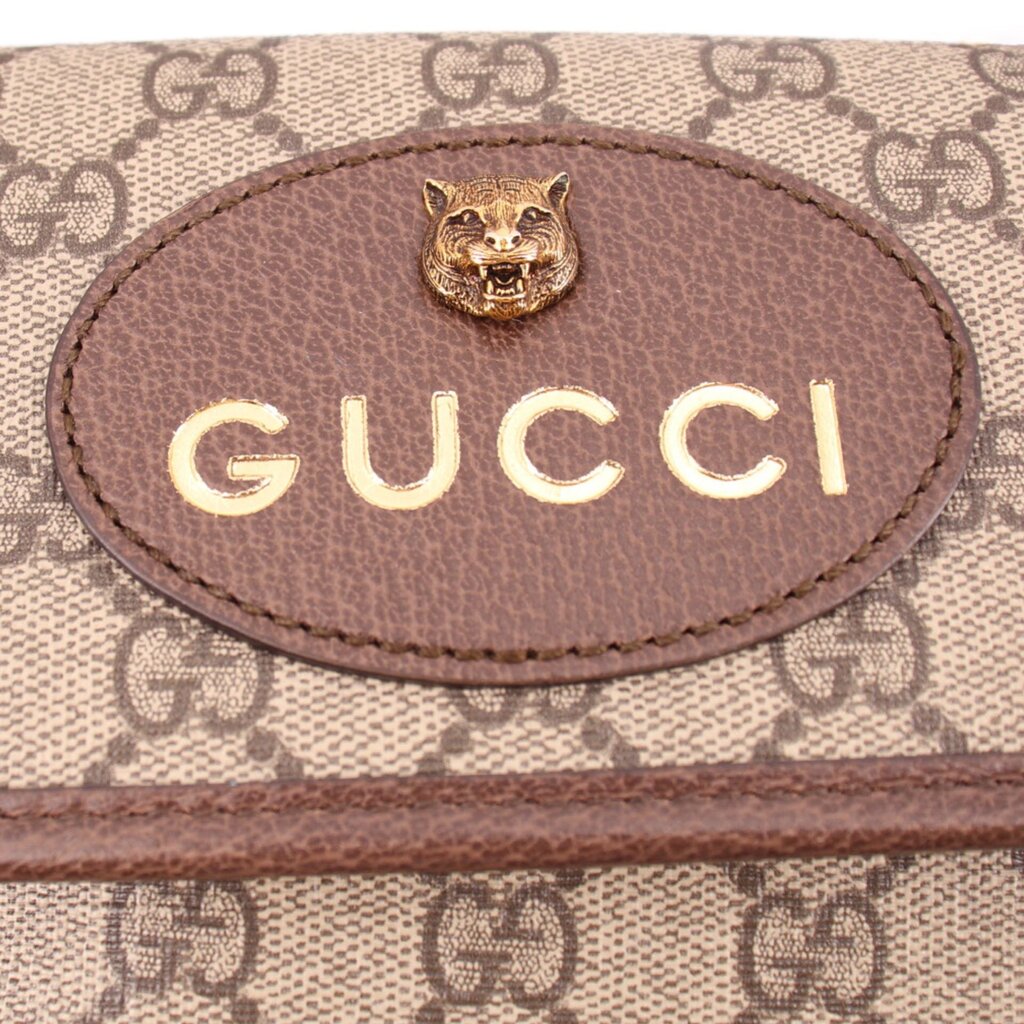 Gucci crossbody front patch with lion head emblem and Gucci lettering on leather