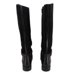 Black knee-high riding boots, back view with zipper panels and cuff strap detail