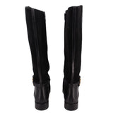 Black knee-high riding boots, back view with zipper panels and cuff strap detail