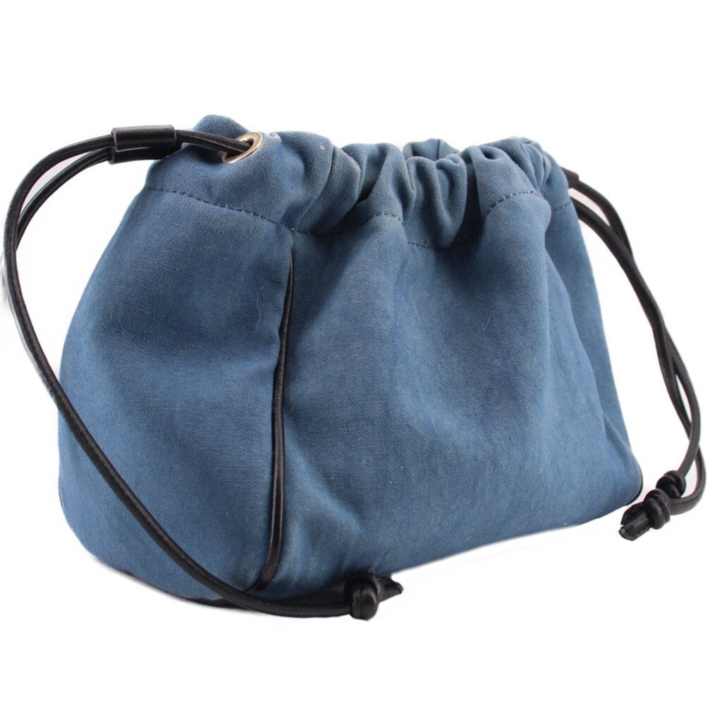 Denim blue drawstring pouch with gathered top, black cords, and metal eyelet