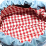 Denim pouch interior with red-and-white gingham lining