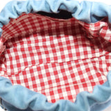 Denim pouch interior with red-and-white gingham lining
